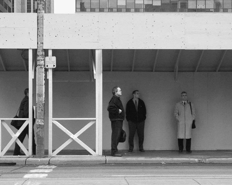 Street photo of people waiting for street car