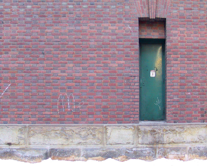 Green door in red brick wall
